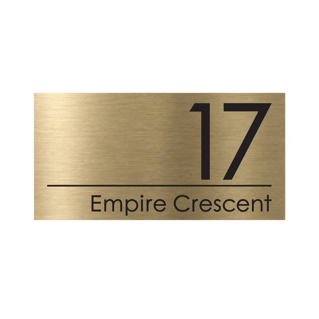 Large brushed gold metallic house sign, 400 x 200 mm, with the house number and street name cut through to a black plate