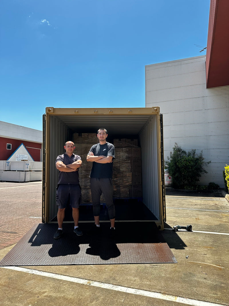 The team at the doors of the first container