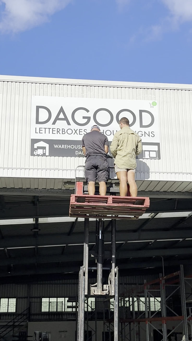 The Dagood sign going up on the Kingston warehouse